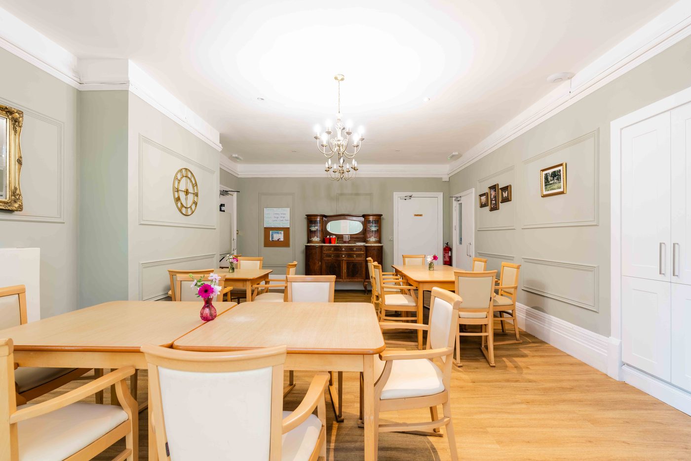 Residents sharing a meal together around the dining table at Wraysbury House